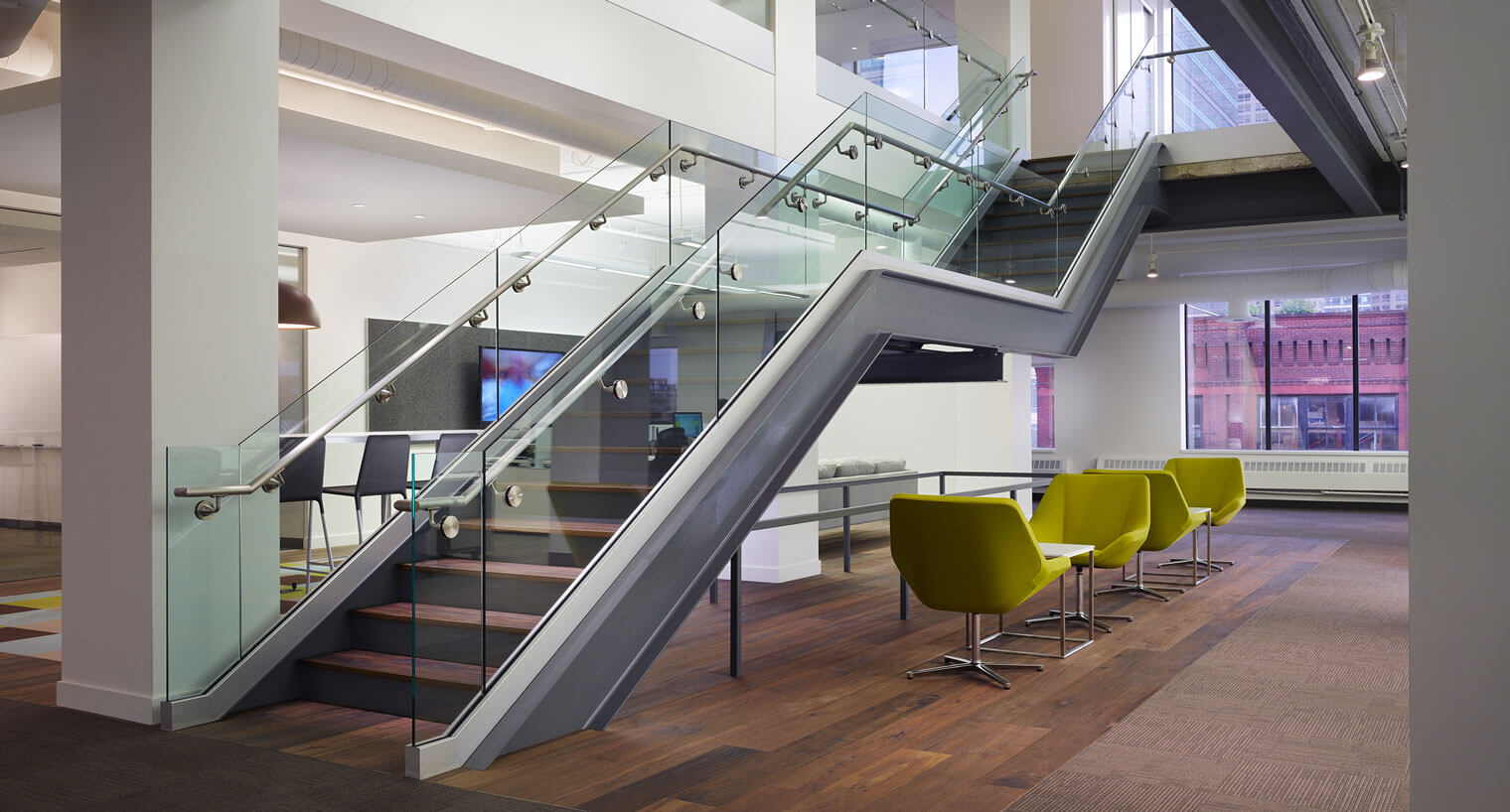 Modern staircase with glass railings in Chicago office space