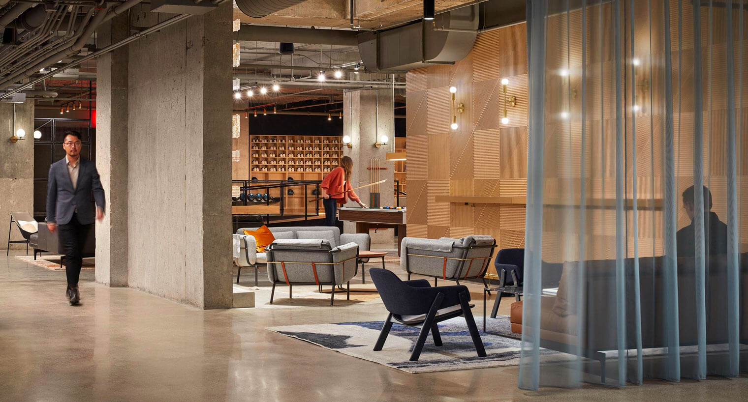 Tenants enjoy a community space with a pool table and couches