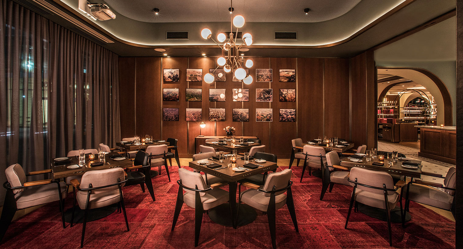 Swift and Sons dining area with red carpet and gallery style art