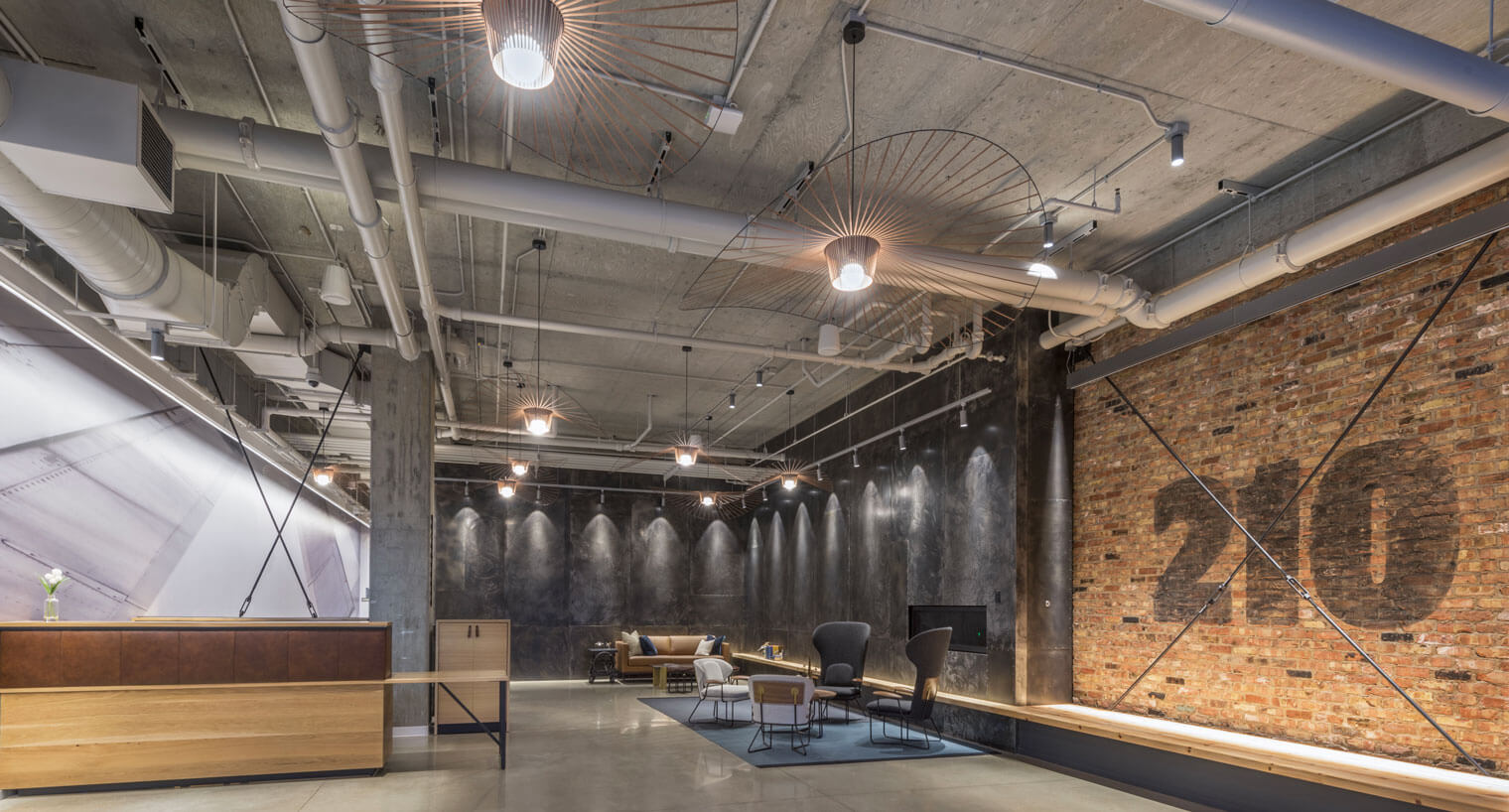 Industrial style community space with brick accent wall