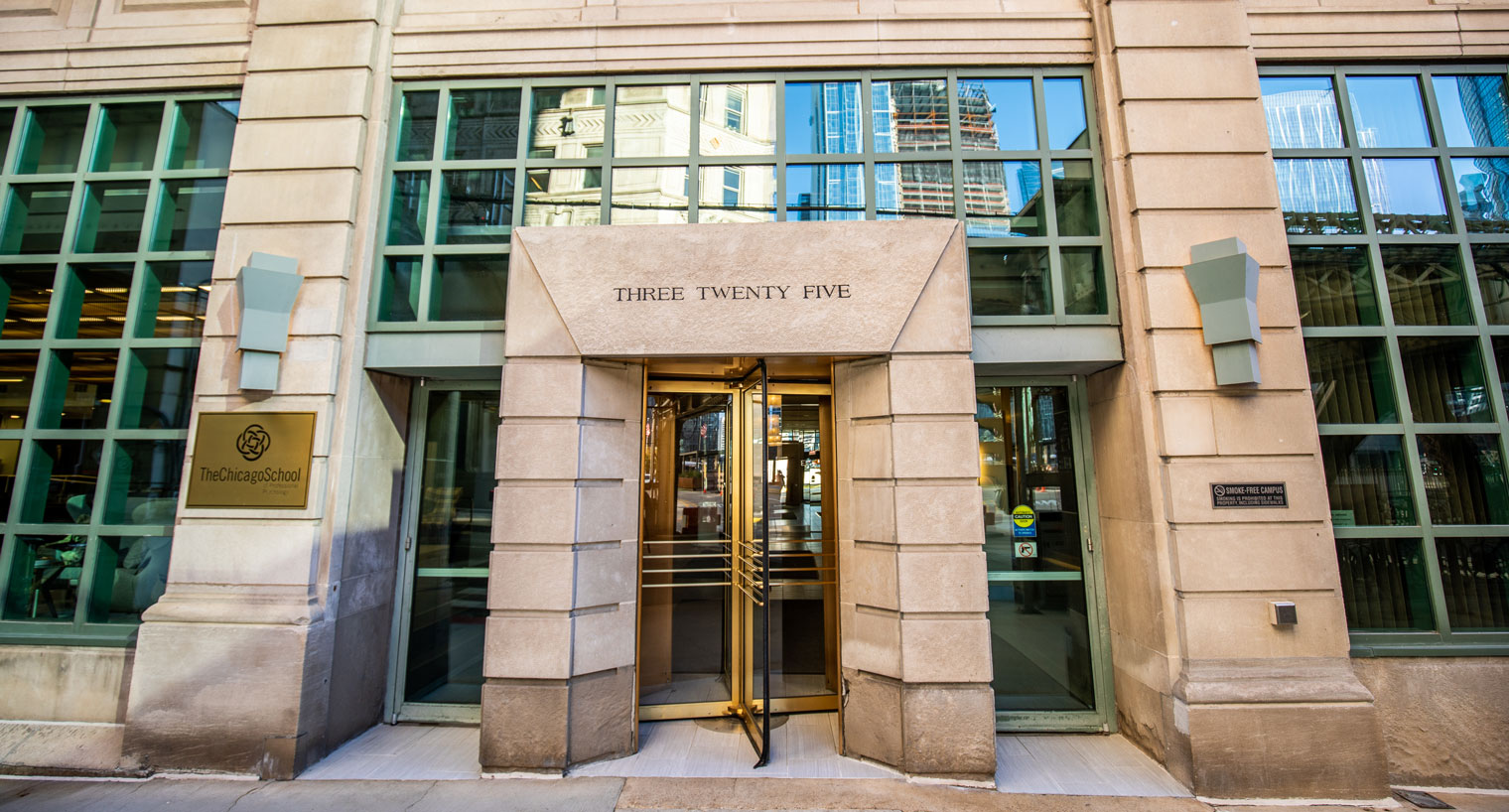 Stone entryway with revolving door in the Chicago school