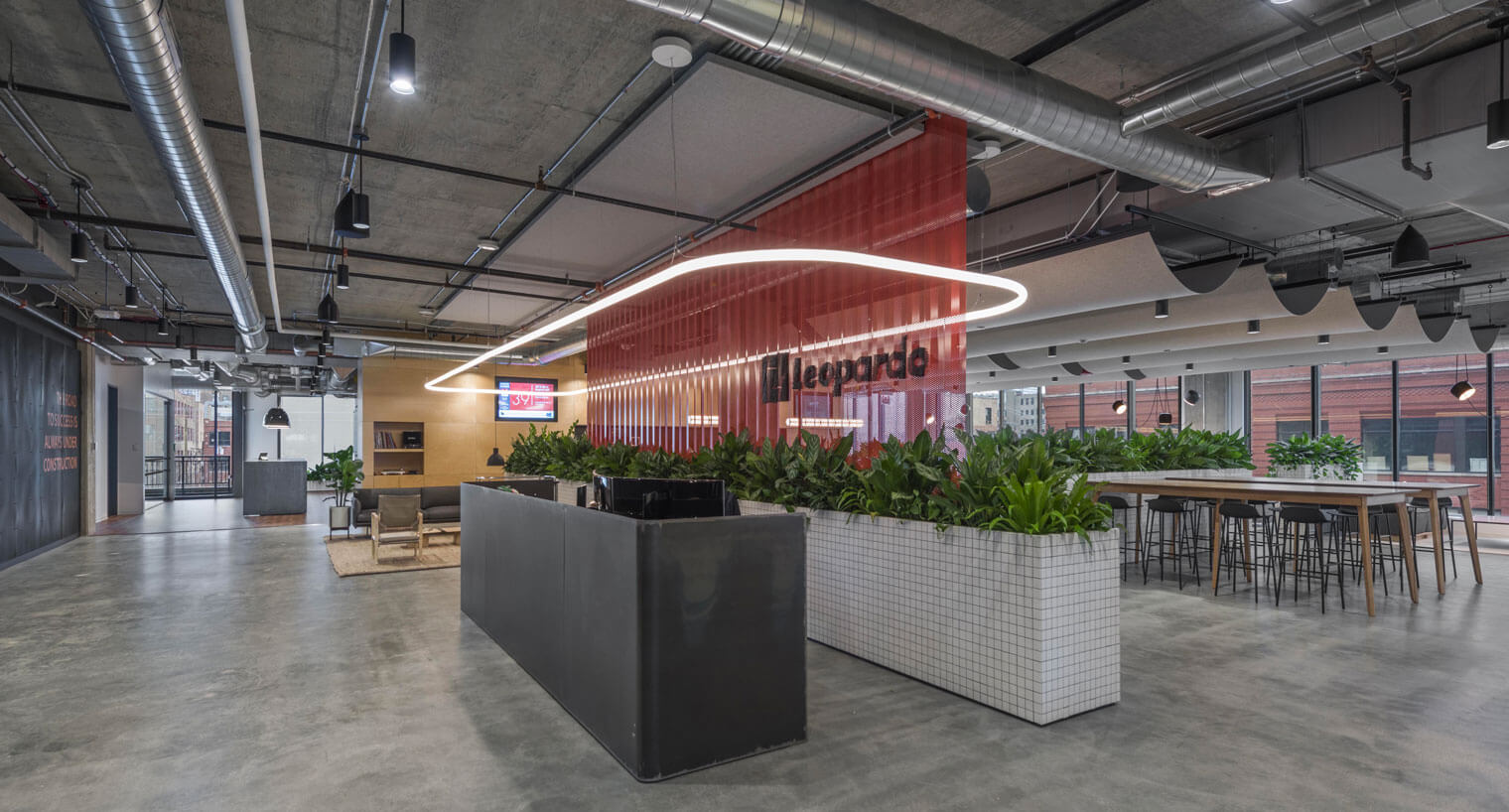 Community space with front desk area and high top tables