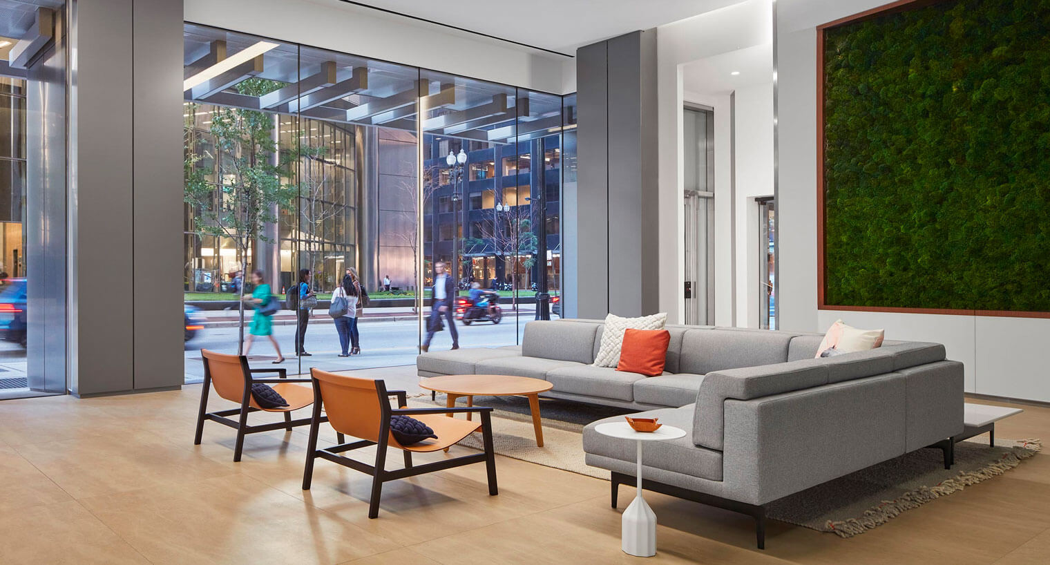 Seating area with floor to ceiling windows looking onto city street