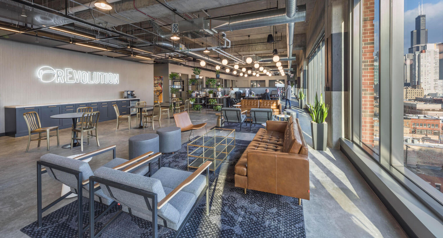 Open concept office space with seating areas and workspaces