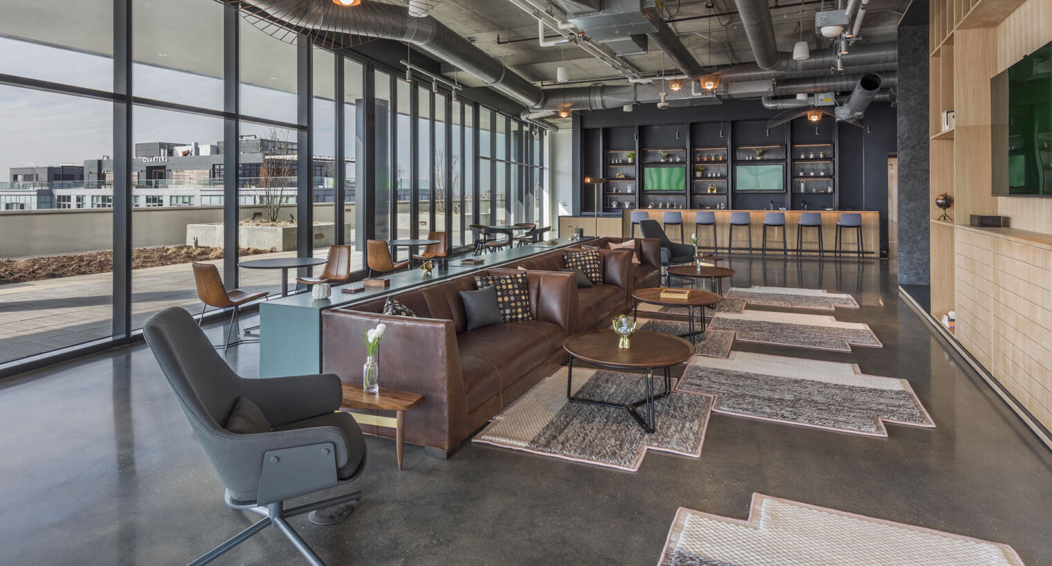 Communal area with seating areas and wall-mounted tvs