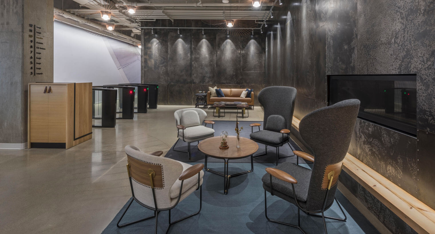 Seating area by building entrance next to built-in fireplace