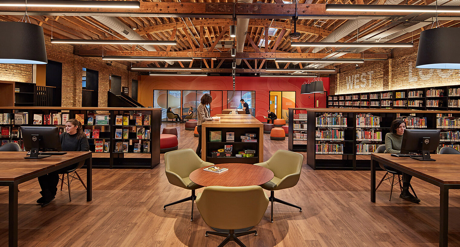 library with finished wood floors, tables, seating and computers