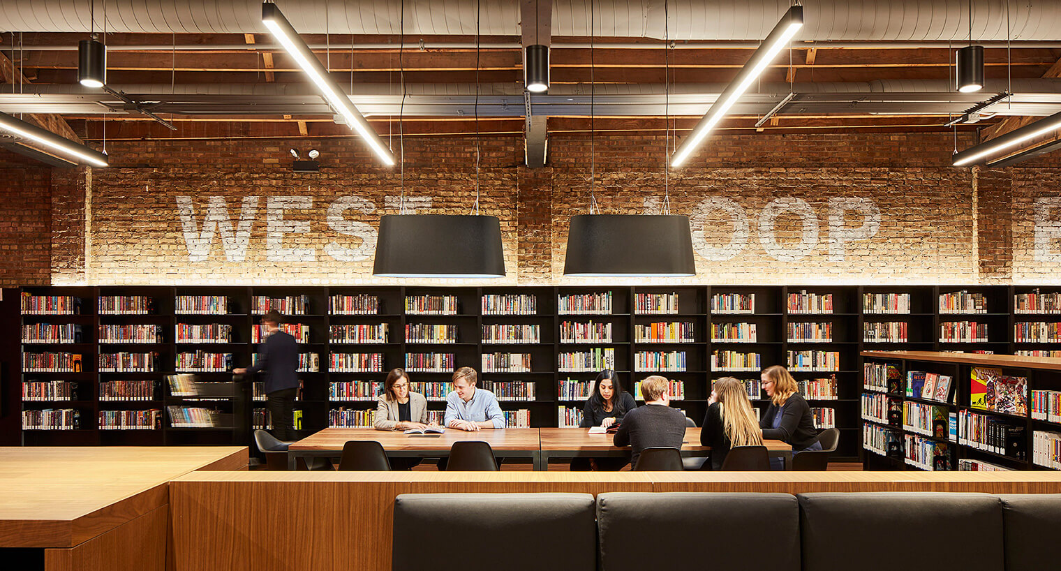 a group of people collaborating at a table in the chicago library