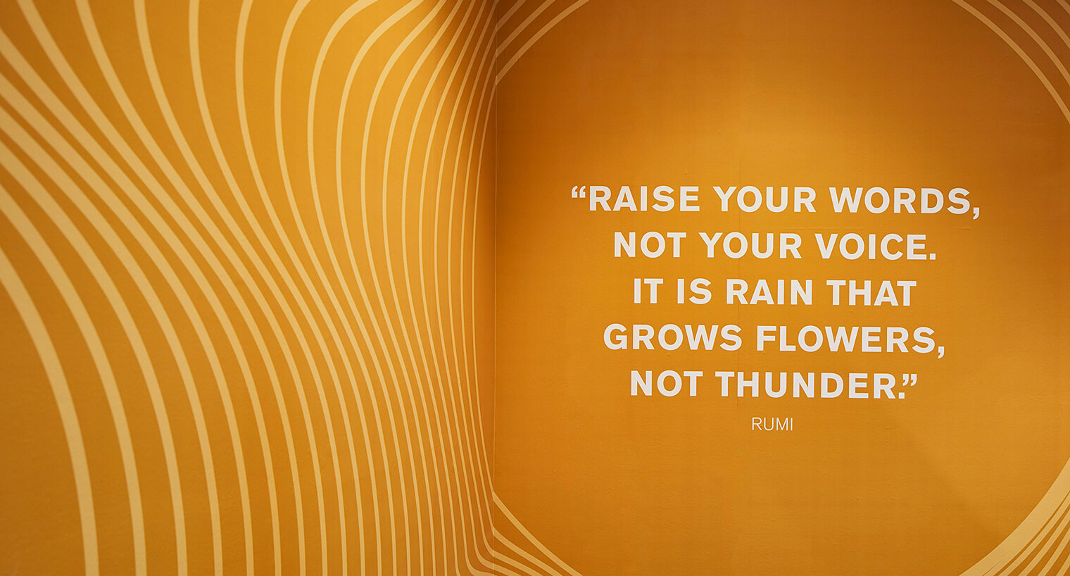 an orange abstract corner with a painted quote by rumi